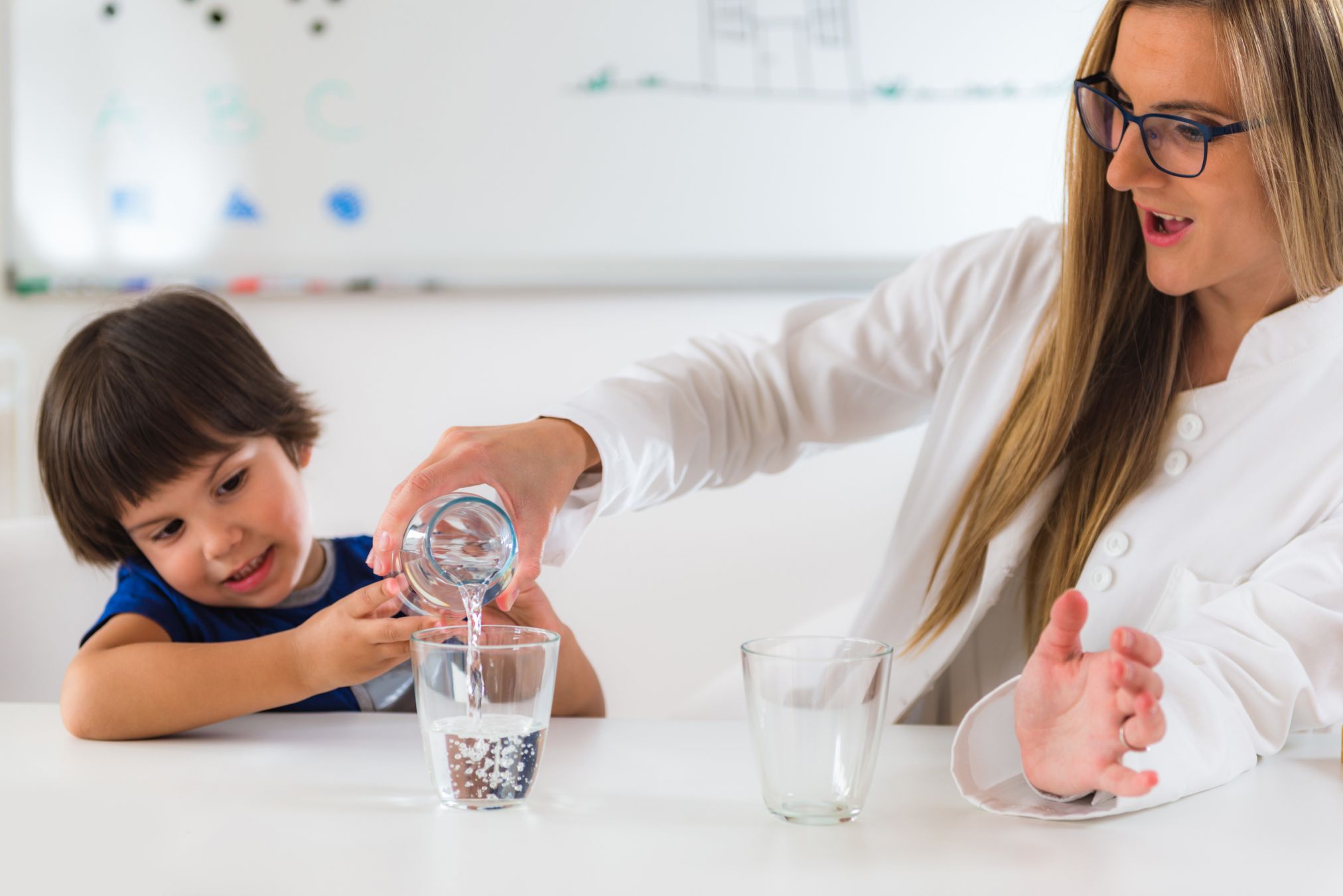 Woman and boy pouring water