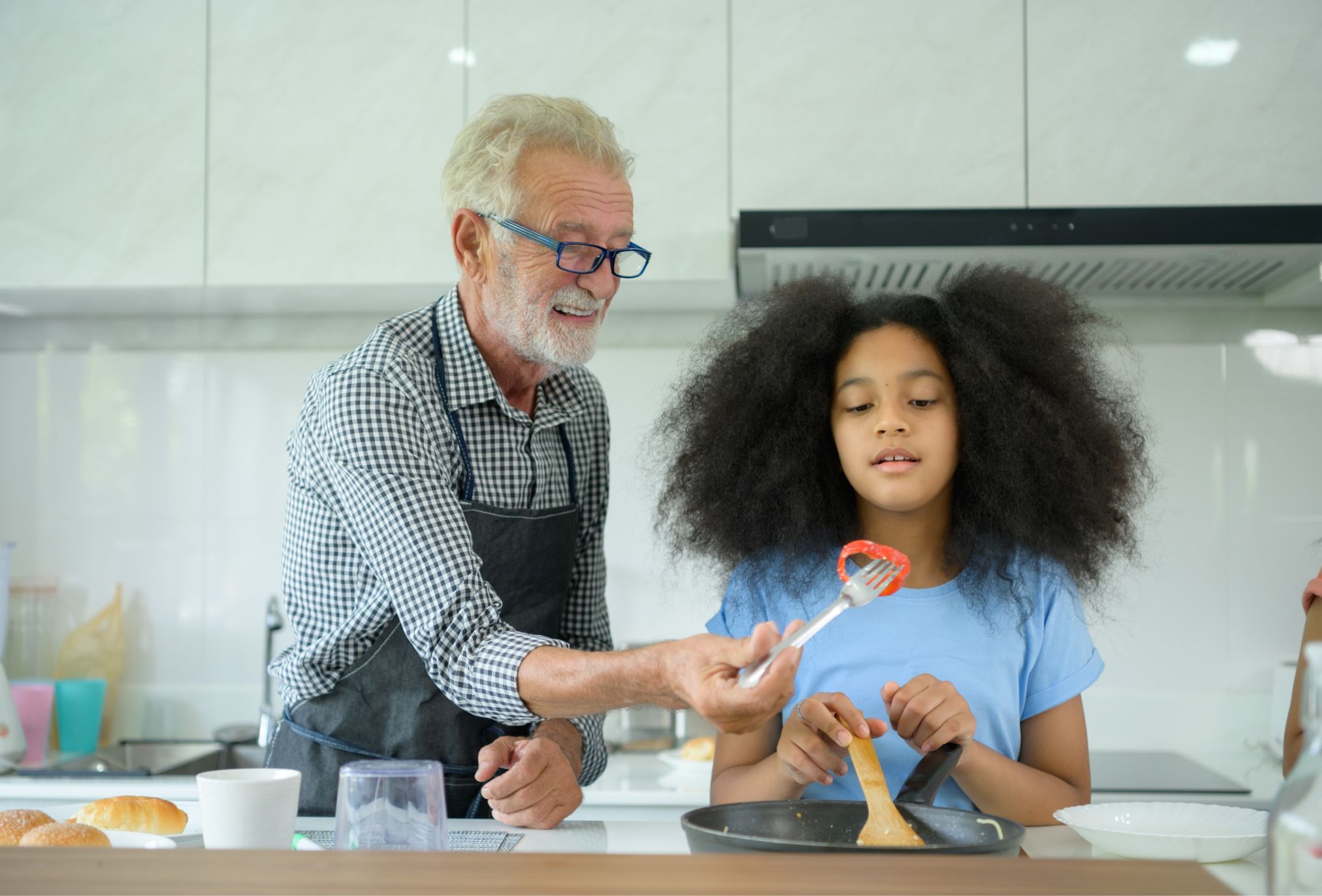 Girl and grandfather cooking