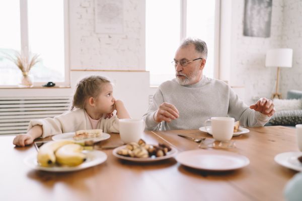 Young girl talking to old man